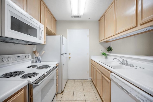 kitchen with sink, light brown cabinets, white appliances, and light tile patterned floors