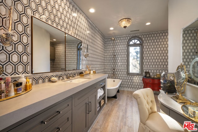 bathroom with vanity, wood-type flooring, and a bathing tub