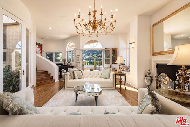 living room featuring wood-type flooring and a chandelier