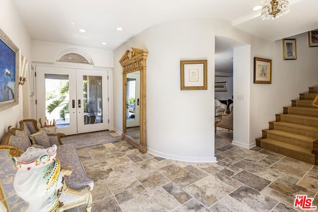 entrance foyer with vaulted ceiling and french doors