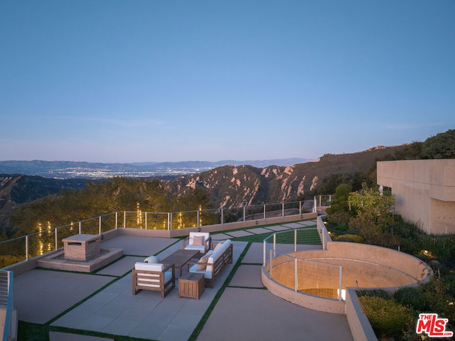 view of swimming pool featuring a mountain view and a patio area