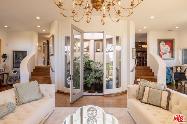 living room featuring light hardwood / wood-style floors and a notable chandelier