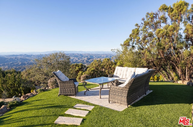 view of yard featuring a mountain view and a patio