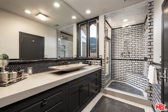 bathroom featuring vanity and decorative backsplash