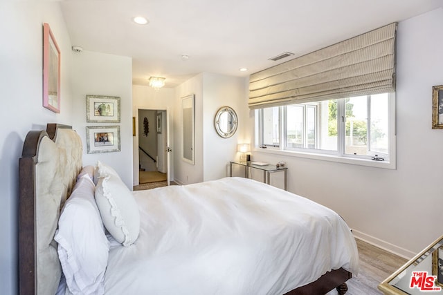 bedroom with light hardwood / wood-style floors