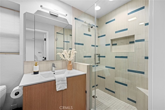 331 Ledroit St, Laguna Beach, CA 92651 - bathroom featuring toilet, vanity, a shower stall, and decorative backsplash