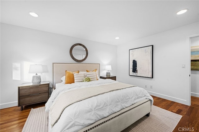 bedroom with dark hardwood / wood-style flooring