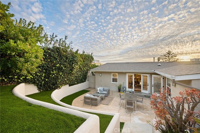 back of property with a yard, a patio area, and outdoor lounge area