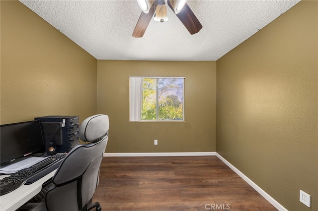 office featuring dark hardwood / wood-style flooring, ceiling fan, and a textured ceiling