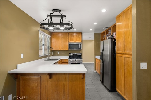 kitchen featuring sink, hanging light fixtures, light tile patterned floors, appliances with stainless steel finishes, and kitchen peninsula