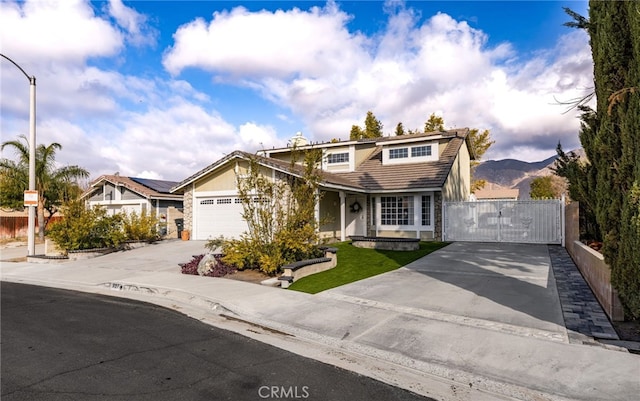 front facade with a garage and a mountain view