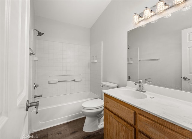 full bathroom with tiled shower / bath, vanity, toilet, and wood-type flooring