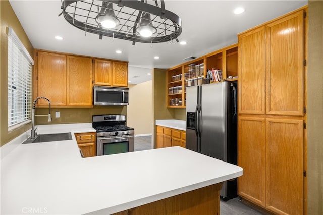 kitchen with sink, light tile patterned floors, stainless steel appliances, and kitchen peninsula