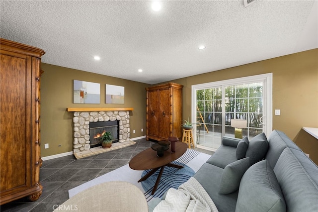 tiled living room with a textured ceiling and a fireplace