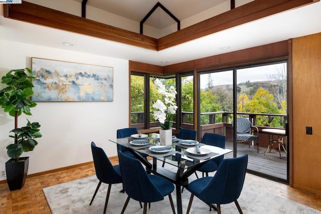 dining area with light parquet floors and a healthy amount of sunlight