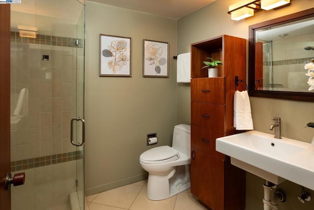 bathroom with an enclosed shower, tile patterned floors, and toilet