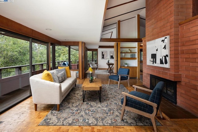 living room with light parquet flooring and a brick fireplace