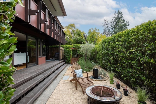 view of patio / terrace with a fire pit and a deck