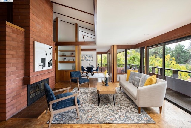 interior space with light parquet flooring, a healthy amount of sunlight, and a fireplace