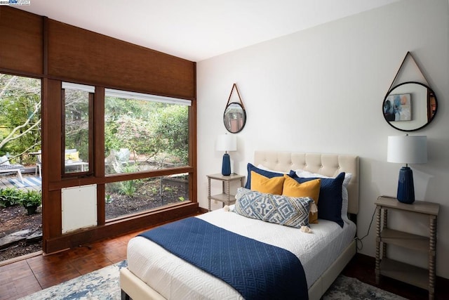 bedroom with dark parquet flooring