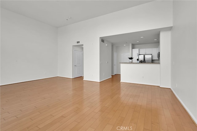 unfurnished room with light hardwood / wood-style floors