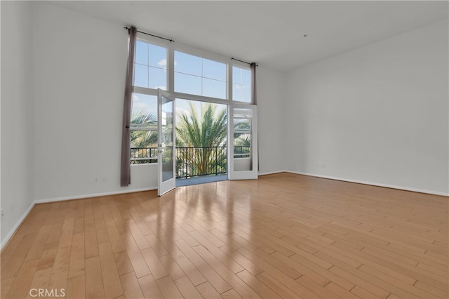 unfurnished room with light hardwood / wood-style floors