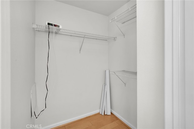 walk in closet featuring hardwood / wood-style floors