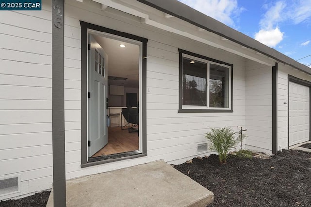 view of exterior entry featuring a garage