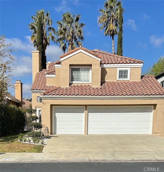 mediterranean / spanish-style home with a garage