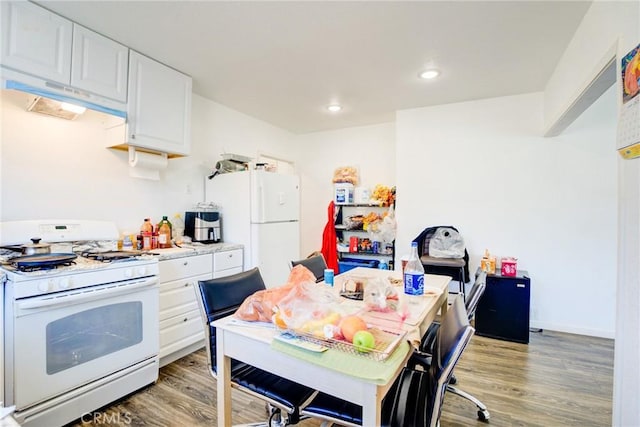 kitchen featuring white cabinetry, white appliances, and wood-type flooring