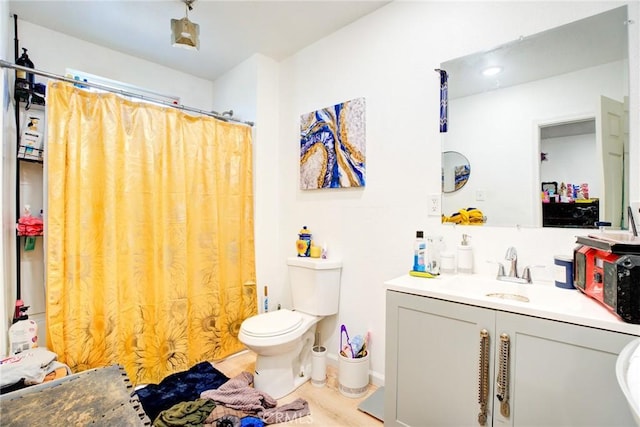 bathroom featuring vanity, toilet, and a shower with shower curtain