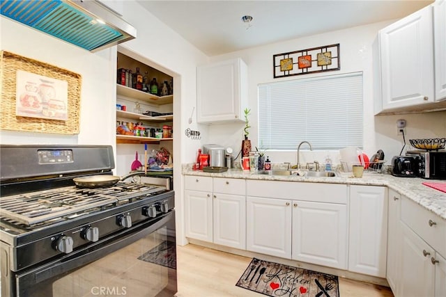 kitchen with white cabinetry, black gas stove, sink, and light stone counters