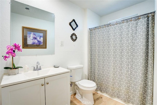 bathroom featuring vanity, hardwood / wood-style floors, curtained shower, and toilet