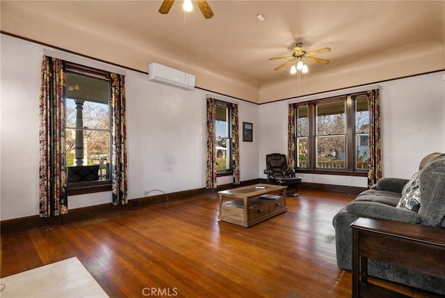 living room with dark hardwood / wood-style flooring, a wealth of natural light, an AC wall unit, and ceiling fan