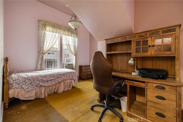 bedroom featuring lofted ceiling and light hardwood / wood-style flooring