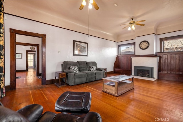 living room featuring hardwood / wood-style floors and ceiling fan