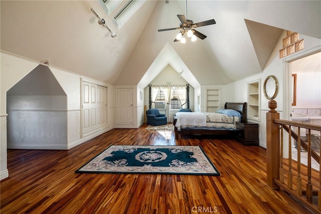 bedroom with dark wood-type flooring and vaulted ceiling with skylight