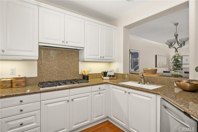 kitchen featuring white cabinetry, appliances with stainless steel finishes, sink, and dark stone counters