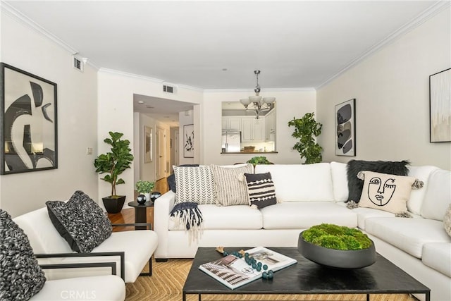 living room with crown molding and a notable chandelier