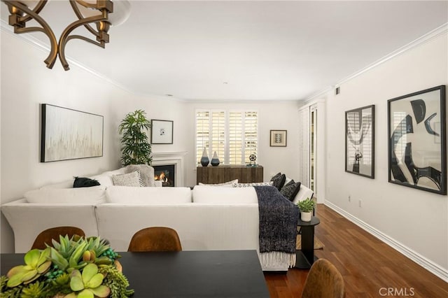 living room featuring dark wood-type flooring and ornamental molding