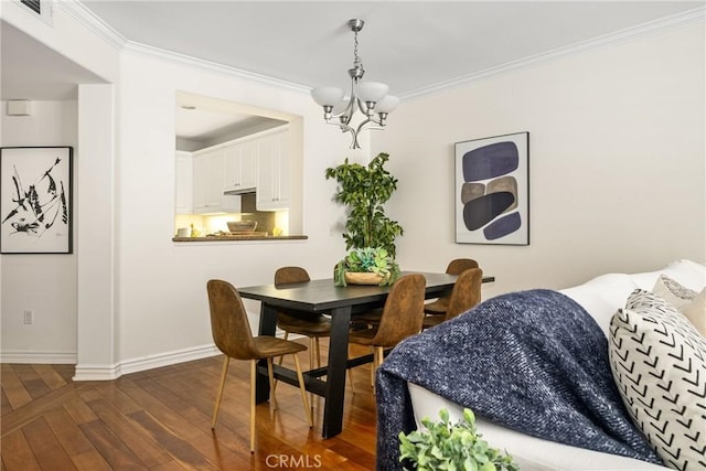 dining space featuring an inviting chandelier, crown molding, and dark wood-type flooring