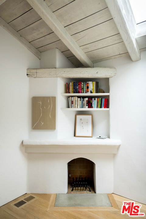 room details with beam ceiling, wooden ceiling, and hardwood / wood-style flooring