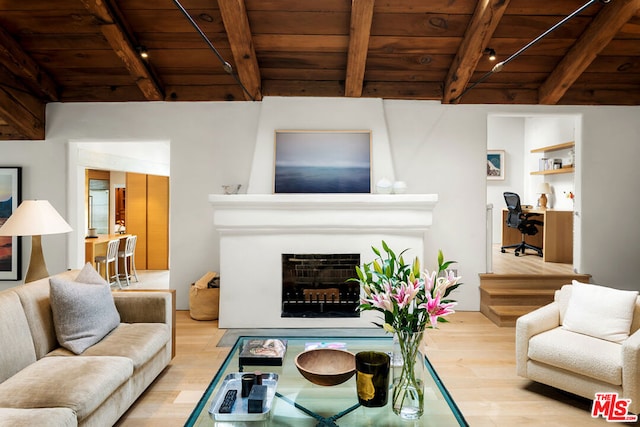 living room featuring beamed ceiling, light hardwood / wood-style floors, and wooden ceiling