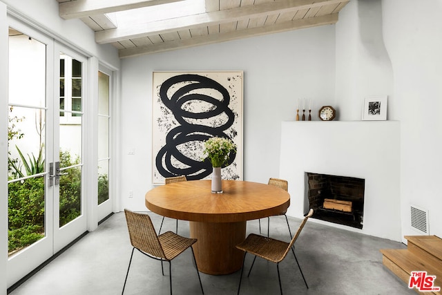 dining room with lofted ceiling with beams, wood ceiling, and french doors