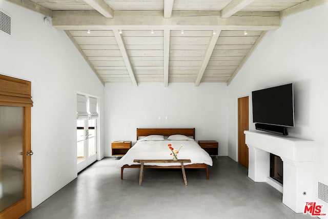 bedroom featuring vaulted ceiling with beams