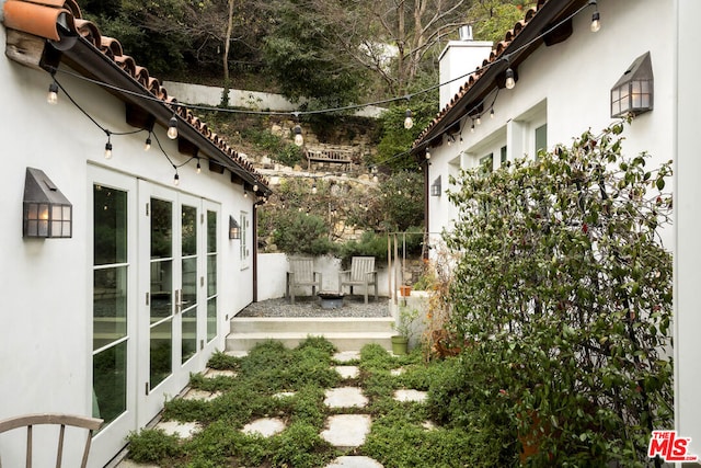 view of yard featuring french doors and a patio area