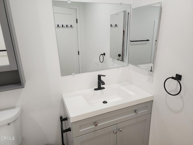 half bath with vanity and toilet