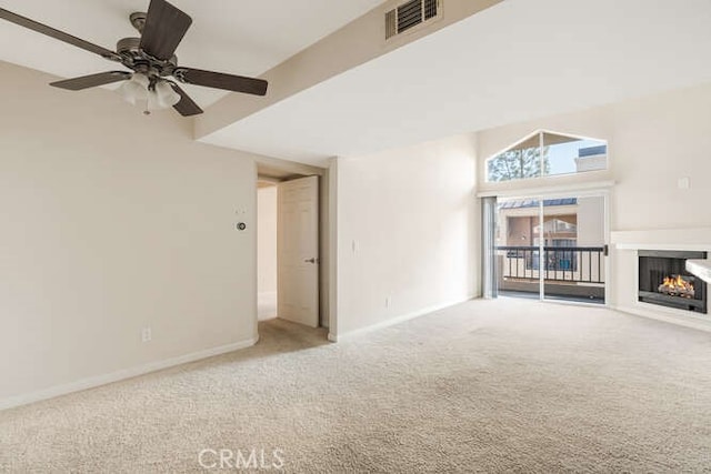 unfurnished living room featuring light colored carpet and ceiling fan