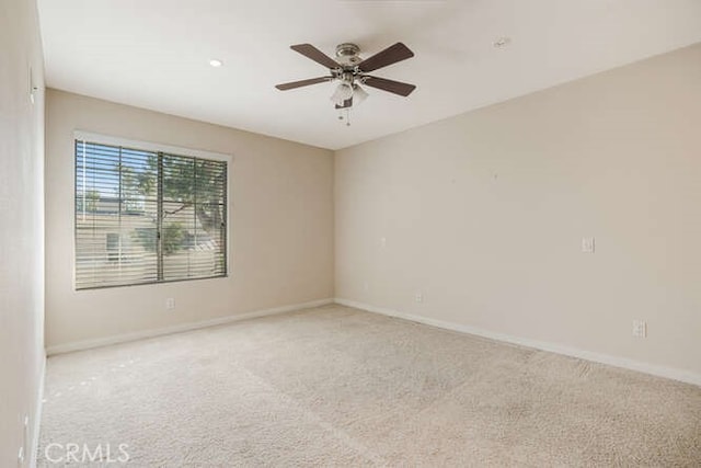 carpeted empty room featuring ceiling fan