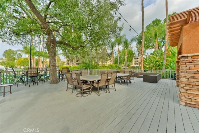 wooden deck with an outdoor living space